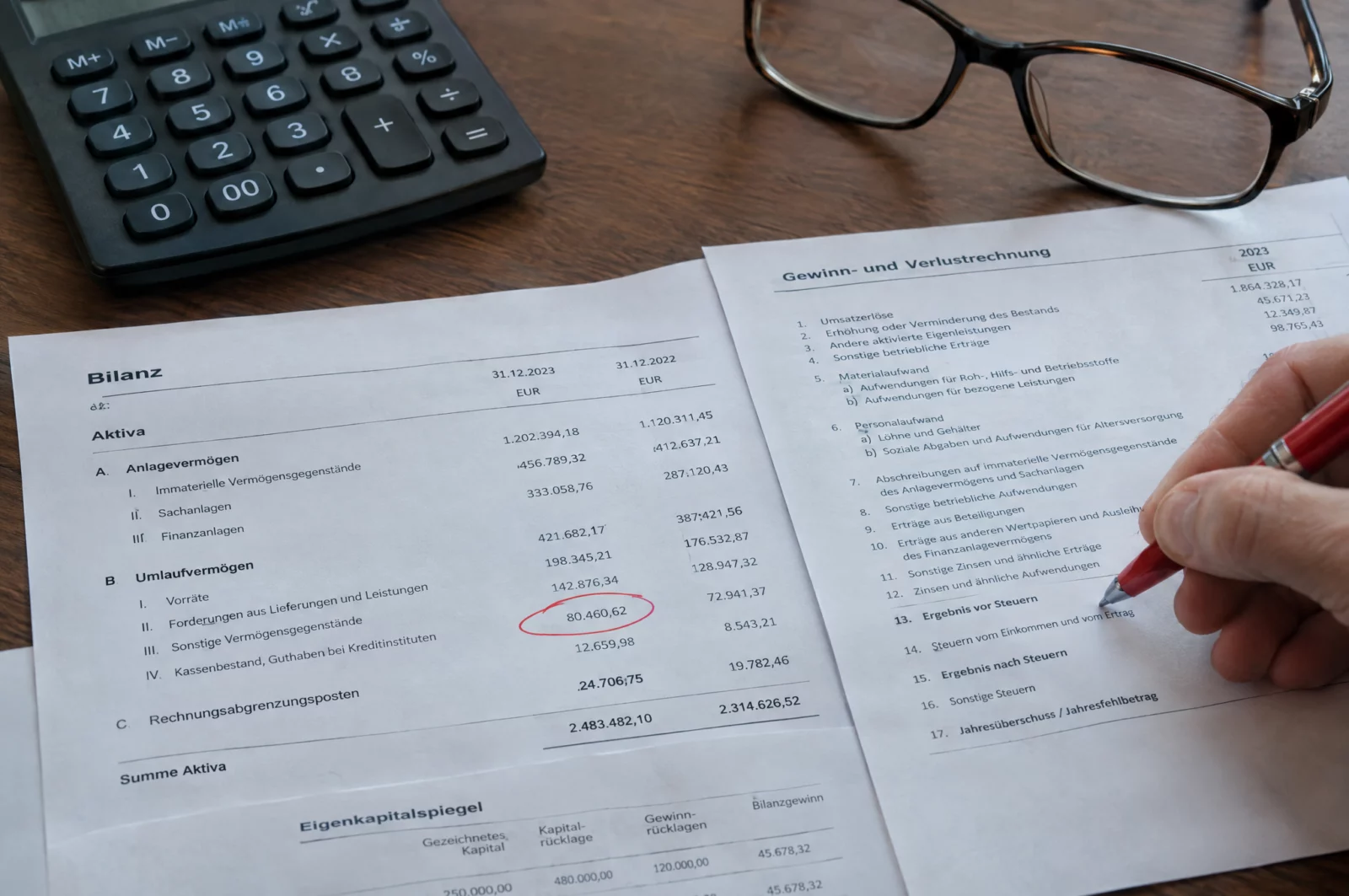 Kreditbetrug - § 265b StGB Ausgedruckte Bilanz und Gewinn- und Verlustrechnung mit rot markierter Zahl, zentrales Beweismittel beim Kreditbetrug.